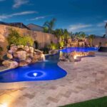 Nighttime pool scene with colored lighting and fire features
